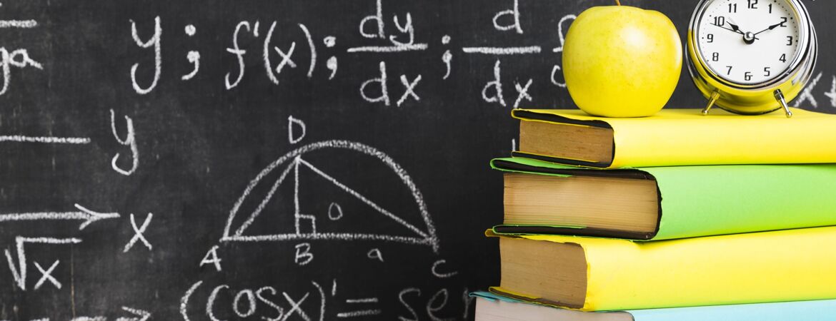 School desk with textbooks near blackboard